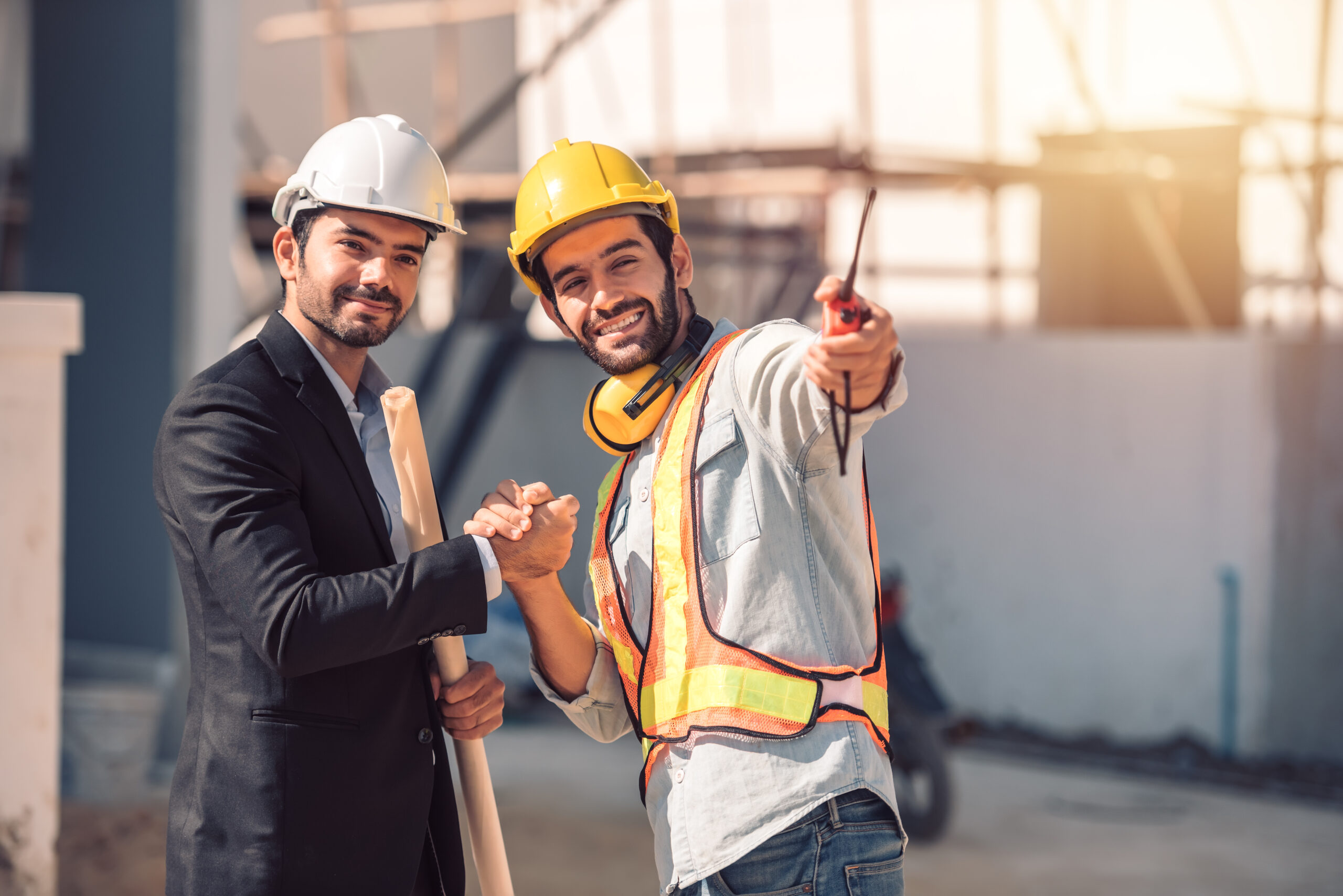 happy-workers-construction-site-young-civil-engineer-manager-architects-handshaking-construction-site-looking-construction-phase-cooperation-teamwork-concept